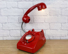 Load image into Gallery viewer, A quirky lamp made from a retro phone. The base of the lamp is a classic red rotary phone with a red dial & alpha numeric ring. The red handset mounted on a flexible gooseneck has a small LED bulb in the receiver converting it into a fabulous lamp.