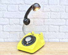 Load image into Gallery viewer, A quirky lamp made from a retro phone. The base of the lamp is a bright yellow rotary phone with a black dial &amp; ring. The black handset mounted on a flexible gooseneck has a small LED bulb in the receiver converting it into a fabulous lamp.
